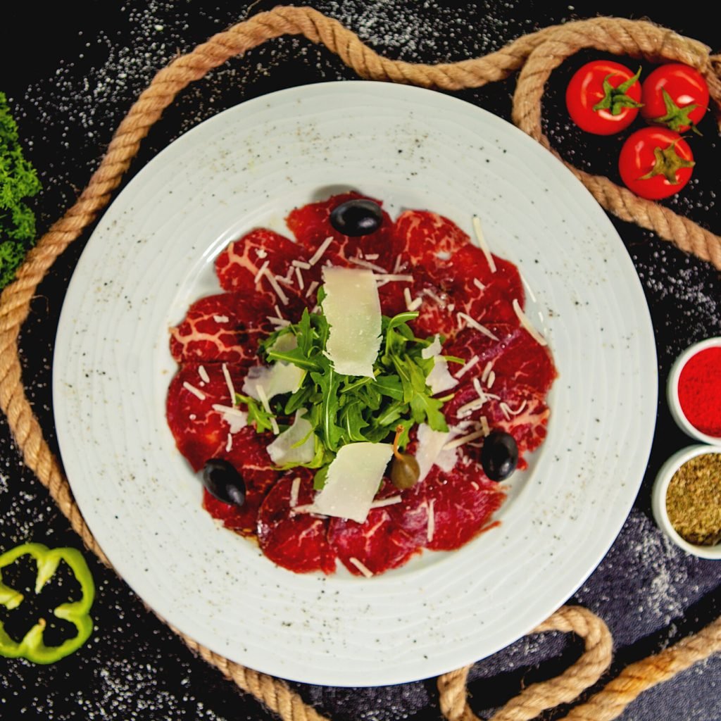 beef carpaccio with parmesan, arugula and olives