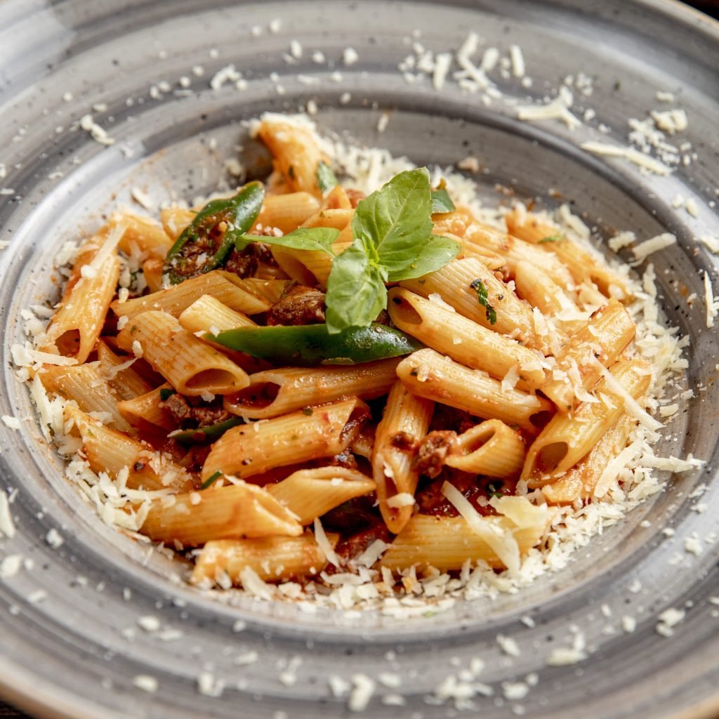 pasta with meat grated cheese and basil leaf